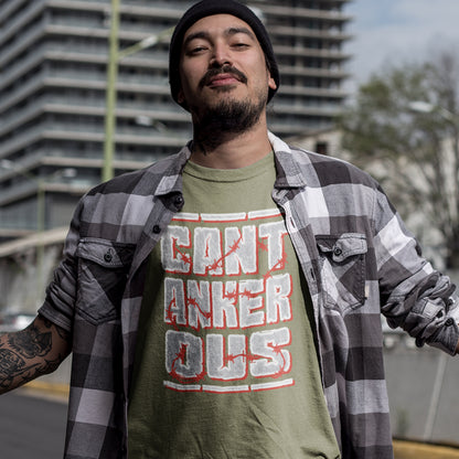 Man wearing a khaki t-shirt with text and a plaid shirt outdoors. A grumpy non conformist t shirt design. Argumentative and pessimistic ? Exercise your disapproval, and be proud to be labelled cantankerous. Made from 100% organic ring-spun cotton, this urban art t shirt is unisex, high-quality, super comfy, and best of all, eco-friendly.