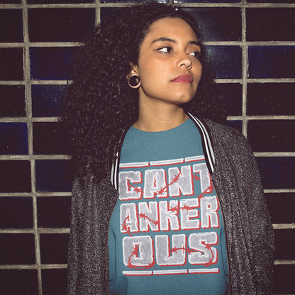 Person wearing a stargazer t-shirt with red and white text against a tiled wall. A grumpy non conformist t shirt design. Argumentative and pessimistic ? Exercise your disapproval, and be proud to be labelled cantankerous. Made from 100% organic ring-spun cotton, this urban art t shirt is unisex, high-quality, super comfy, and best of all, eco-friendly.