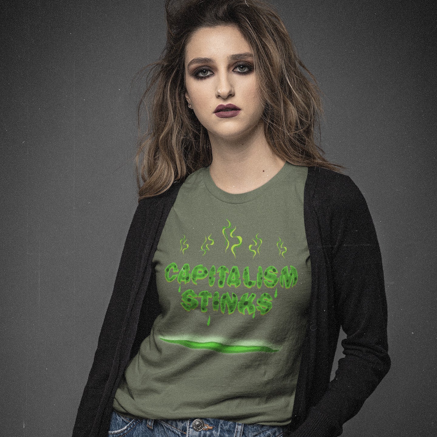 Person wearing a khaki t-shirt with 'CAPITALISM STINKS' text on a dark background. A funny anti-capitalist t-shirt exposing capitalism for what it really is. Let's face it, Capitalism has had it's day and is just rotting peoples ethics and promoting greed. Show your alternative view with this humorous political t-shirt. Made from 100% organic ring-spun cotton, this anti-capitalist t-shirt is unisex, high-quality, super comfy, and best of all, eco-friendly.