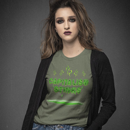 Person wearing a khaki t-shirt with 'CAPITALISM STINKS' text on a dark background. A funny anti-capitalist t-shirt exposing capitalism for what it really is. Let's face it, Capitalism has had it's day and is just rotting peoples ethics and promoting greed. Show your alternative view with this humorous political t-shirt. Made from 100% organic ring-spun cotton, this anti-capitalist t-shirt is unisex, high-quality, super comfy, and best of all, eco-friendly.