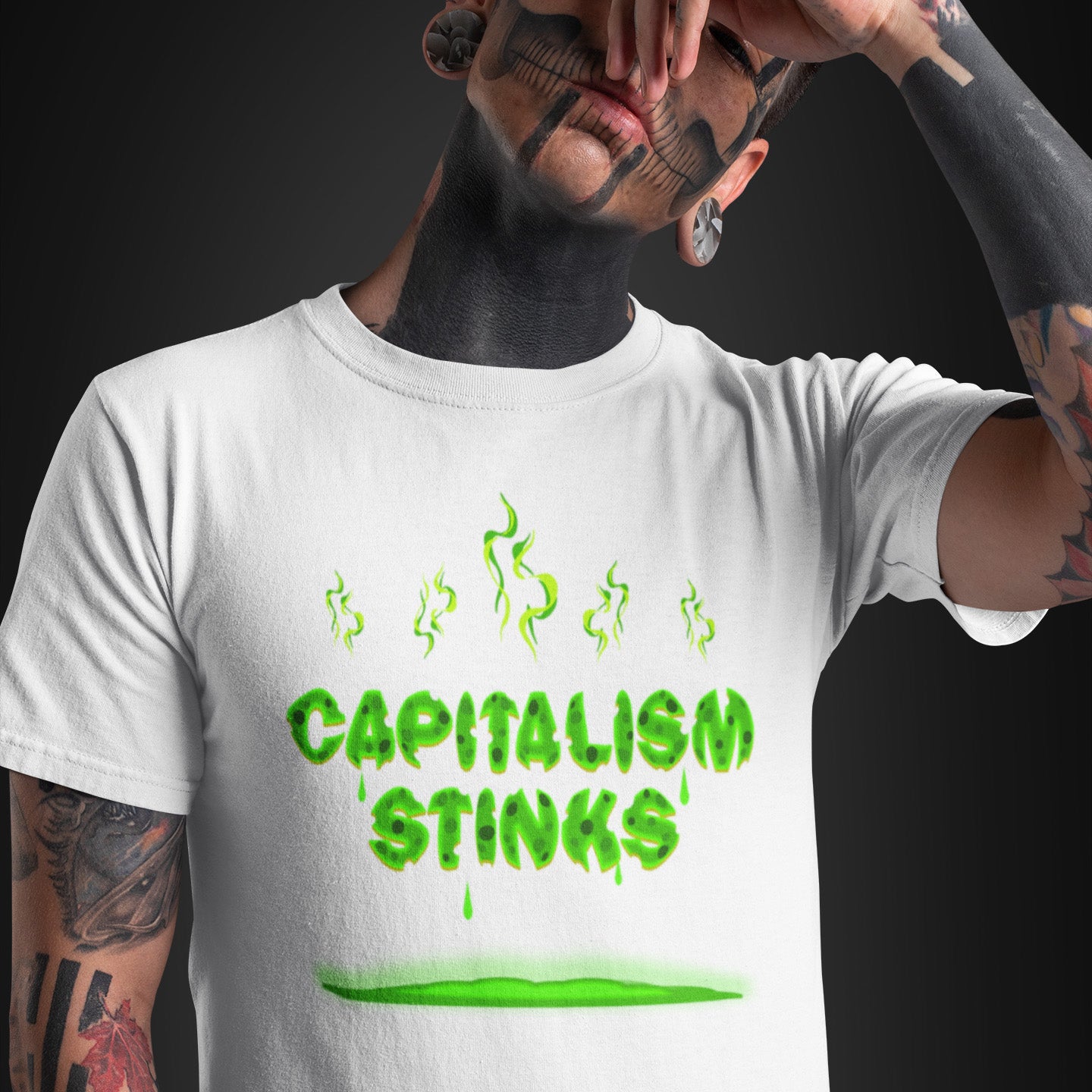 Person wearing a white t-shirt with 'CAPITALISM STINKS' in green text. A funny anti-capitalist t-shirt exposing capitalism for what it really is. Let's face it, Capitalism has had it's day and is just rotting peoples ethics and promoting greed. Show your alternative view with this humorous political t-shirt. Made from 100% organic ring-spun cotton, this anti-capitalist t-shirt is unisex, high-quality, super comfy, and best of all, eco-friendly.