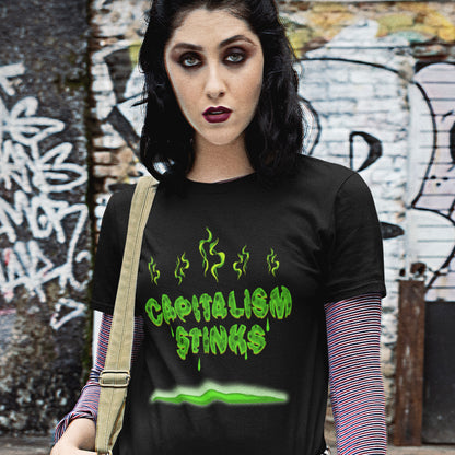 Person wearing a black t-shirt with 'CAPITALISM STINKS' text in green against a graffiti-covered wall. A funny anti capitalism t shirt exposing capitalism for what it really is. Let's face it, Capitalism has had it's day and is just rotting peoples ethics and promoting greed. Show your alternative view with this funny political t shirt. Made from 100% organic ring-spun cotton, this anti-capitalist t shirt is unisex, high-quality, super comfy, and best of all, eco-friendly.