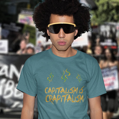 Person wearing a stargazer t-shirt with 'CAPITALISM IS CRAPITALISM' text in a protest setting. A funny anti-capitalism t-shirt suggesting a letter was left out of the naming of capitalism. This unique anti-establishment t-shirt design argues that the system is crap. Made from 100% organic ring-spun cotton, this anti-capitalist t-shirt is unisex, high-quality, super comfy, and best of all, eco-friendly.