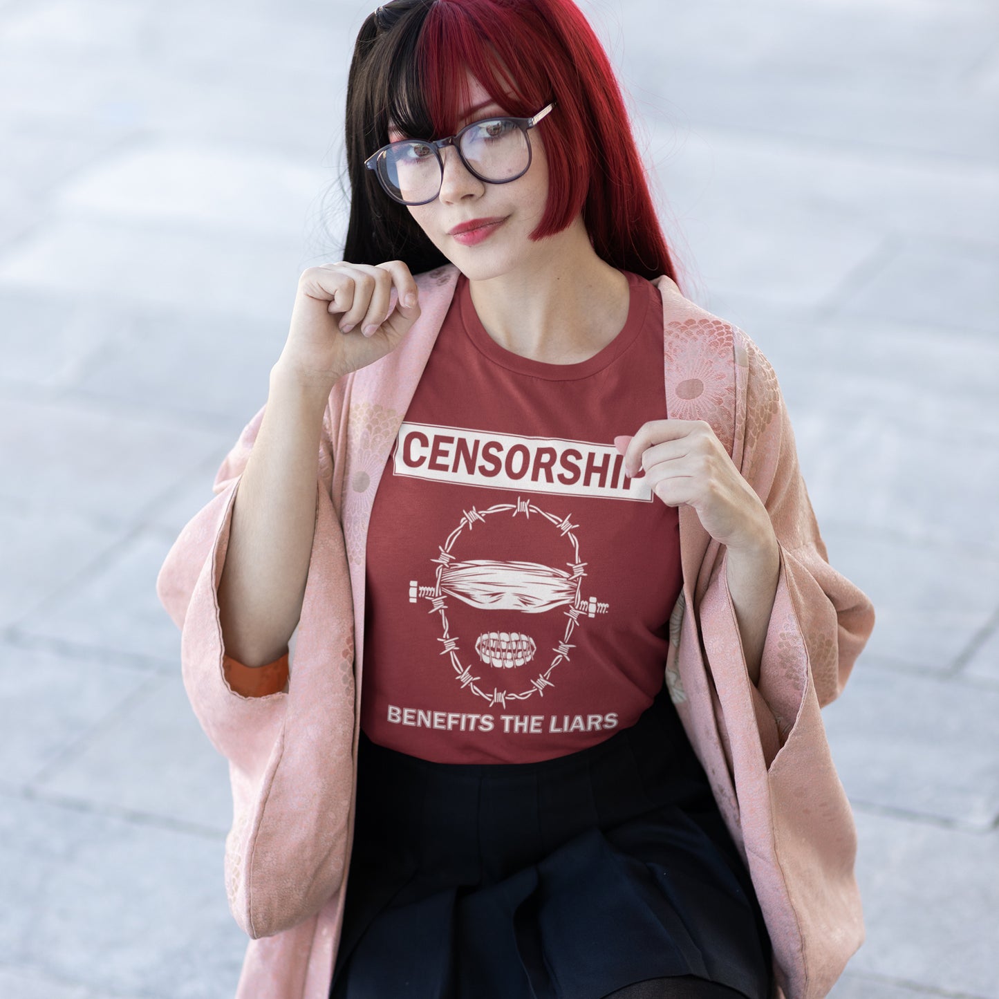 Person wearing a burgundy t-shirt with 'CENSORSHIP BENEFITS THE LIARS' text and graphic. This civil rights t shirt highlights the negative benefits of censorship. Lies and censorship go hand-in-hand as tools of control and manipulation. This unique design promotes social awareness and freedom of speech. Made from 100% organic ring-spun cotton, this no censorship t shirt is unisex, high-quality, super comfy, and best of all, eco-friendly.