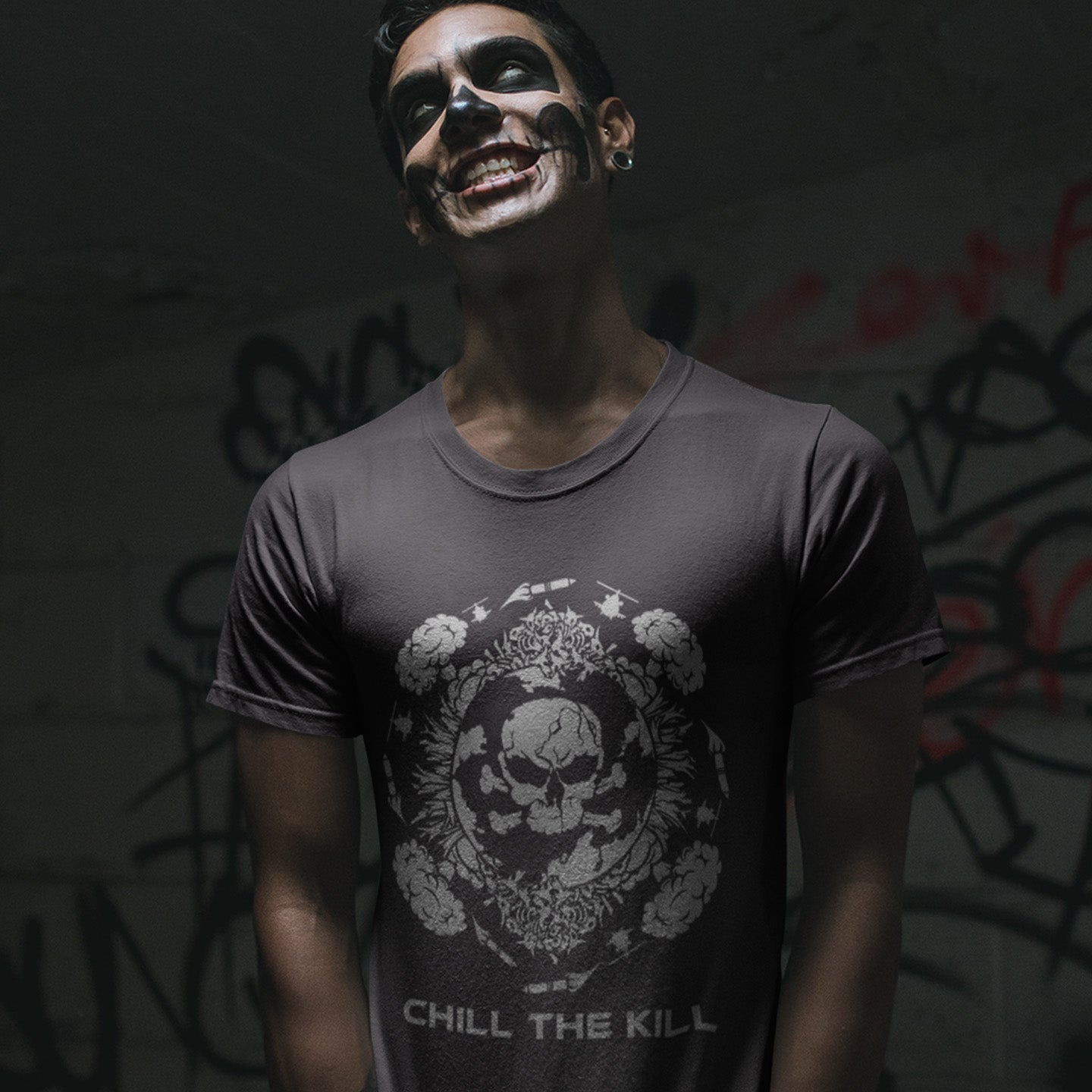 Person wearing a dark t-shirt with a  standing against a graffiti-covered wall. An original save the planet t-shirt. A unique creation in a series of designs about environmental issues and climate concern. This one highlighting the amount of death and destruction we create as a species. Express your counterculture alternative view and encourage social awareness. Made from 100% organic ring-spun cotton, this political t-shirt is unisex, high-quality, super comfy, and best of all, eco-friendly.