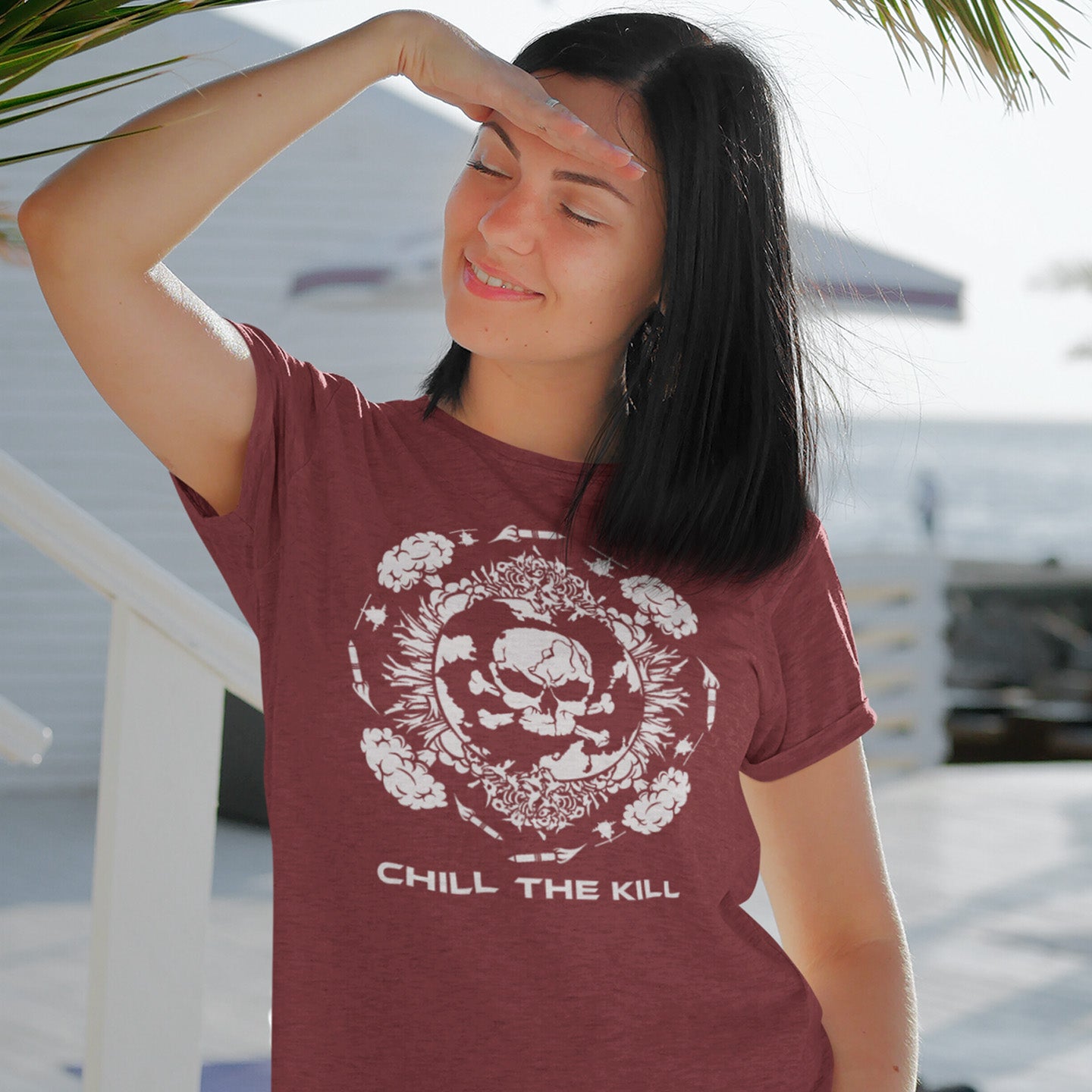 Woman wearing a burgundy t-shirt with a graphic design and text. An original save the planet t-shirt. A unique creation in a series of designs about environmental issues and climate concern. This one highlighting the amount of death and destruction we create as a species. Express your counterculture alternative view and encourage social awareness. Made from 100% organic ring-spun cotton, this political t-shirt is unisex, high-quality, super comfy, and best of all, eco-friendly.