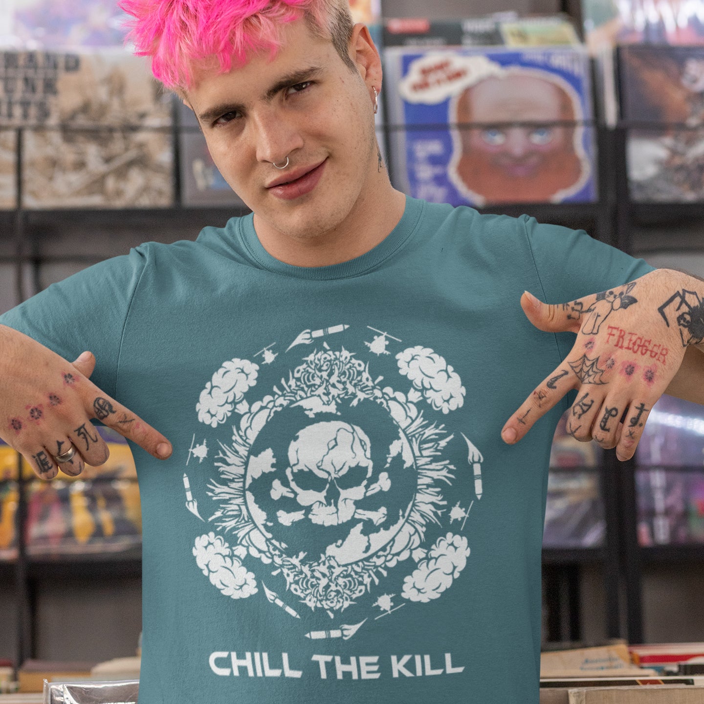 Person wearing a teal t-shirt with a skull design and 'Chill the Kill' text. An original save the planet t-shirt. A unique creation in a series of designs about environmental issues and climate concern. This one highlighting the amount of death and destruction we create as a species. Express your counterculture alternative view and encourage social awareness. Made from 100% organic ring-spun cotton, this political t-shirt is unisex, high-quality, super comfy, and best of all, eco-friendly.