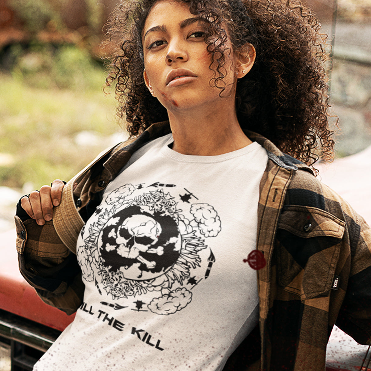 Person wearing a white t-shirt with a graphic design and text, standing outdoors. An original save the planet t-shirt. A unique creation in a series of designs about environmental issues and climate concern. This one highlighting the amount of death and destruction we create as a species. Express your counterculture alternative view and encourage social awareness. Made from 100% organic ring-spun cotton, this political t-shirt is unisex, high-quality, super comfy, and best of all, eco-friendly.