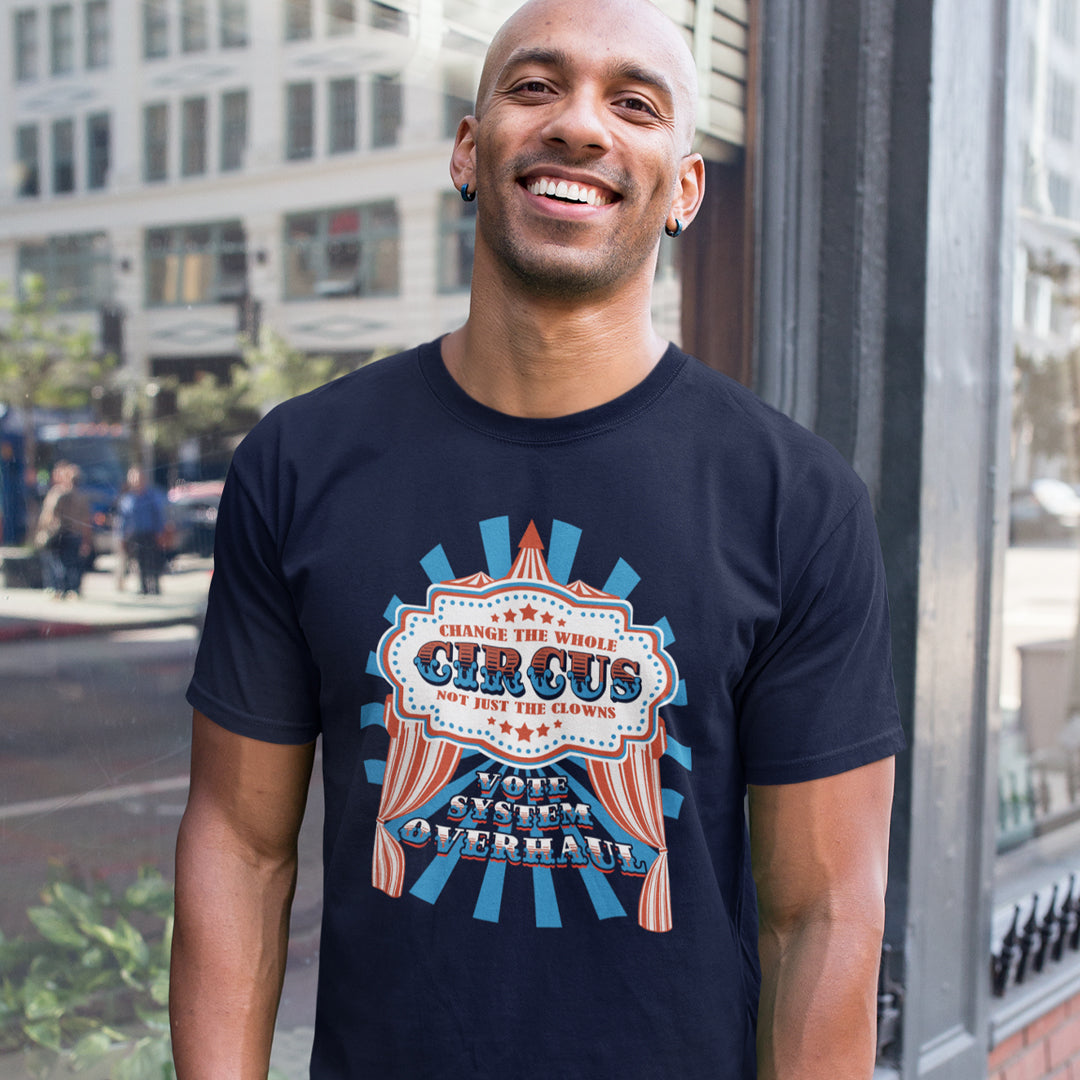 Man wearing a navy blue t-shirt with a colourful graphic design on a city street. This anti government t shirt points out that you can change the clowns but the circus remains. Does it matter who fronts a corrupt system? The whole circus needs to go. Made from 100% organic ring-spun cotton, this civil rights t shirt is unisex, high-quality, super comfy, and best of all, eco-friendly.