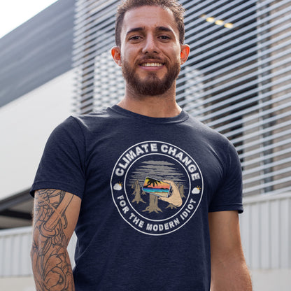 Man wearing a t-shirt with 'Climate Change for the Modern Idiot' design outdoors. A satirical save the planet t-shirt exposing the denial still opposing a very serious issue. In this age of smart technology it's surprising there isn't an app that helps us ignore the climate crisis. Satire at it's best. Made from 100% organic ring-spun cotton, this social awareness t-shirt is unisex, high-quality, super comfy, and best of all, eco-friendly.