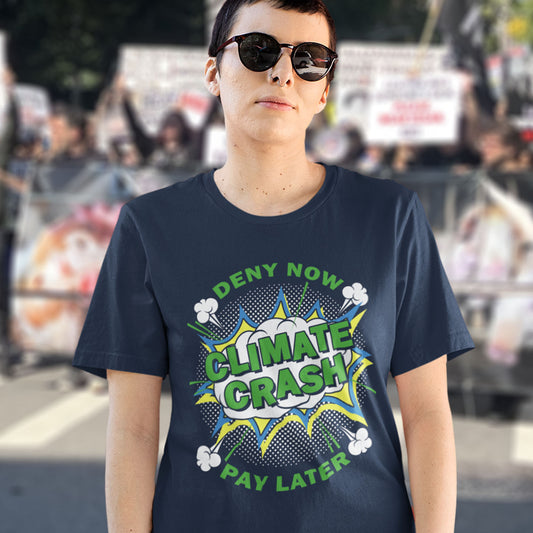 Person wearing a French navy blue t-shirt with 'Climate Crash' graphic design in an outdoor setting.  A satirical save the planet t-shirt designed in a supermarket discount 'Price Crash' style with a play on the 'Buy Now, Pay Later' catchphrase. A dark but witty view of how we need to care more if we want to save the Earth. Made from 100% organic ring-spun cotton, this save the world t shirt is unisex, high-quality, super comfy, and best of all, eco-friendly.