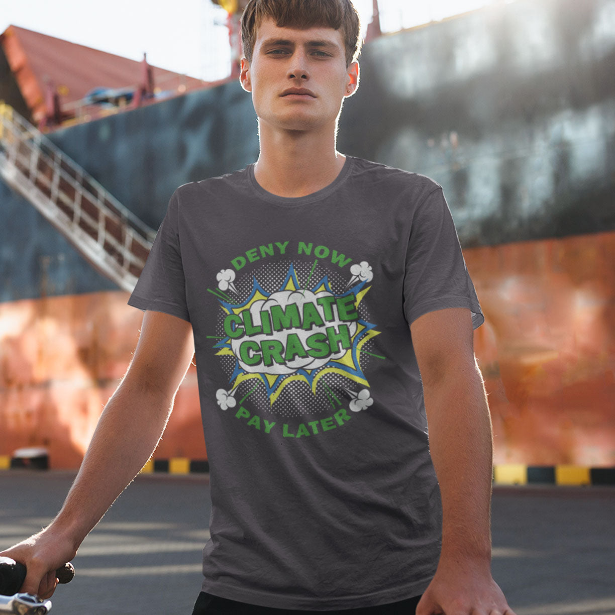 Person wearing a t-shirt with 'Climate Crash' graphic design outdoors.  A satirical save the planet t-shirt designed in a supermarket discount 'Price Crash' style with a play on the 'Buy Now, Pay Later' catchphrase. A dark but witty view of how we need to care more if we want to save the Earth. Made from 100% organic ring-spun cotton, this save the world t shirt is unisex, high-quality, super comfy, and best of all, eco-friendly.