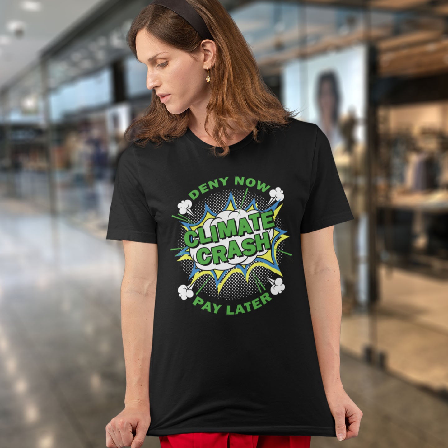 Person wearing a black t-shirt with a climate change message in an indoor setting.  A satirical save the planet t-shirt designed in a supermarket discount 'Price Crash' style with a play on the 'Buy Now, Pay Later' catchphrase. A dark but witty view of how we need to care more if we want to save the Earth. Made from 100% organic ring-spun cotton, this save the world t shirt is unisex, high-quality, super comfy, and best of all, eco-friendly.