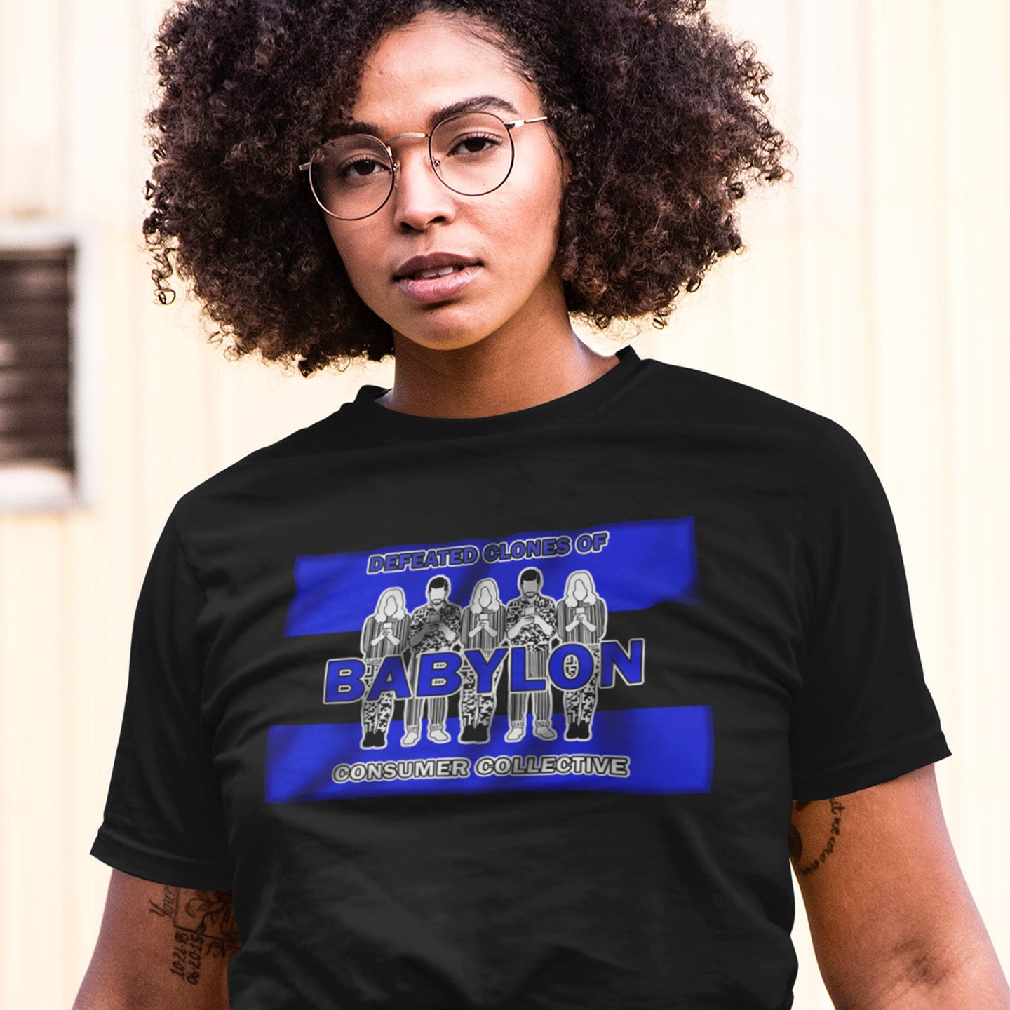 Person wearing a black t-shirt with a graphic design and text. This non conformist t shirt is for people with more than a pessimistic view of society and what we have become. This unique design has a Rastafarian hint as it suggests we fill our world with unnecessary distractions, ignoring more important issues. Made from 100% organic ring-spun cotton, this anti consumerism t shirt is unisex, high-quality, super comfy, and best of all, eco-friendly.