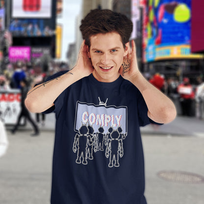 Person wearing a navy blue t-shirt with a graphic design in an urban setting. A non conformist t shirt portraying mistrust for the media. This satirical design highlights the television's role in modern day manipulation and mind control. With social media now being blamed for misinformation and gaslighting, the TV is the Godfather of brainwashing. Made from 100% organic ring-spun cotton, this counter culture t shirt is unisex, high quality, super comfy, and best of all, eco-friendly.