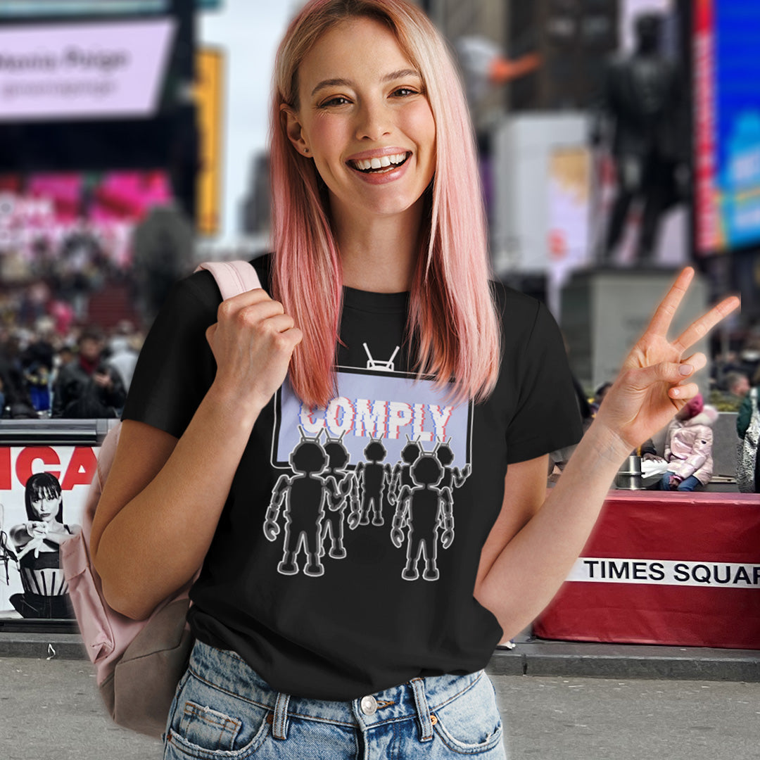 Woman wearing a black t-shirt with graphic design in Times Square, New York City. A non conformist t shirt portraying mistrust for the media. This satirical design highlights the television's role in modern day manipulation and mind control. With social media now being blamed for misinformation and gaslighting, the TV is the Godfather of brainwashing. Made from 100% organic ring-spun cotton, this counter culture t shirt is unisex, high quality, super comfy, and best of all, eco-friendly.