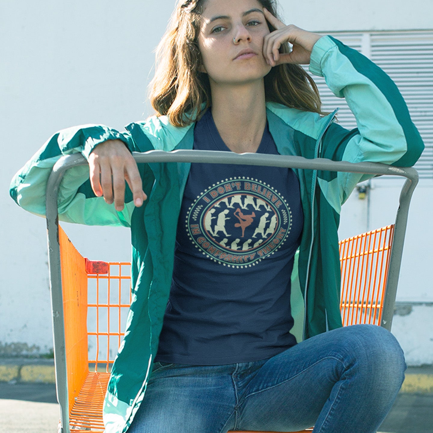 Person wearing a French navy blue t-shirt with a graphic design, sitting on a shopping cart. An anti-conformist t-shirt promoting independent thought. Some people do what they are told without question and wait to be given their opinion. This alternative t-shirt is for the other people. This unique design helps create social awareness of diversity. Made from 100% organic ring-spun cotton, this counterculture t-shirt is unisex, high-quality, super comfy, and best of all, eco-friendly.