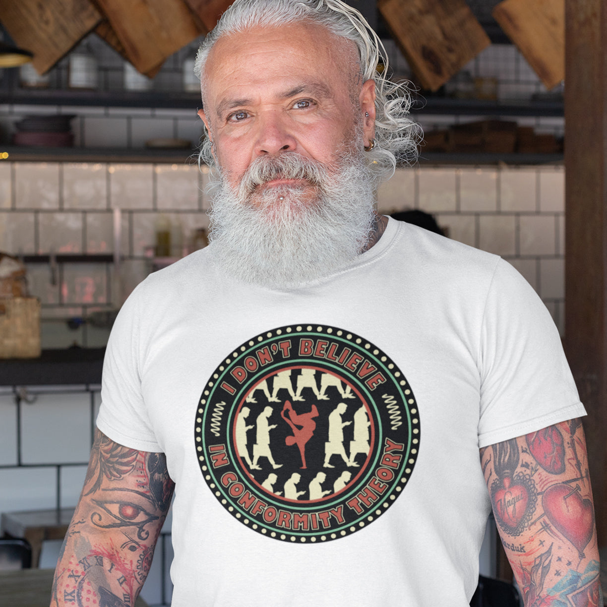 Man wearing a white t-shirt with a graphic design in a casual setting. An anti-conformist t-shirt promoting independent thought. Some people do what they are told without question and wait to be given their opinion. This alternative t-shirt is for the other people. This unique design helps create social awareness of diversity. Made from 100% organic ring-spun cotton, this counterculture t-shirt is unisex, high-quality, super comfy, and best of all, eco-friendly.