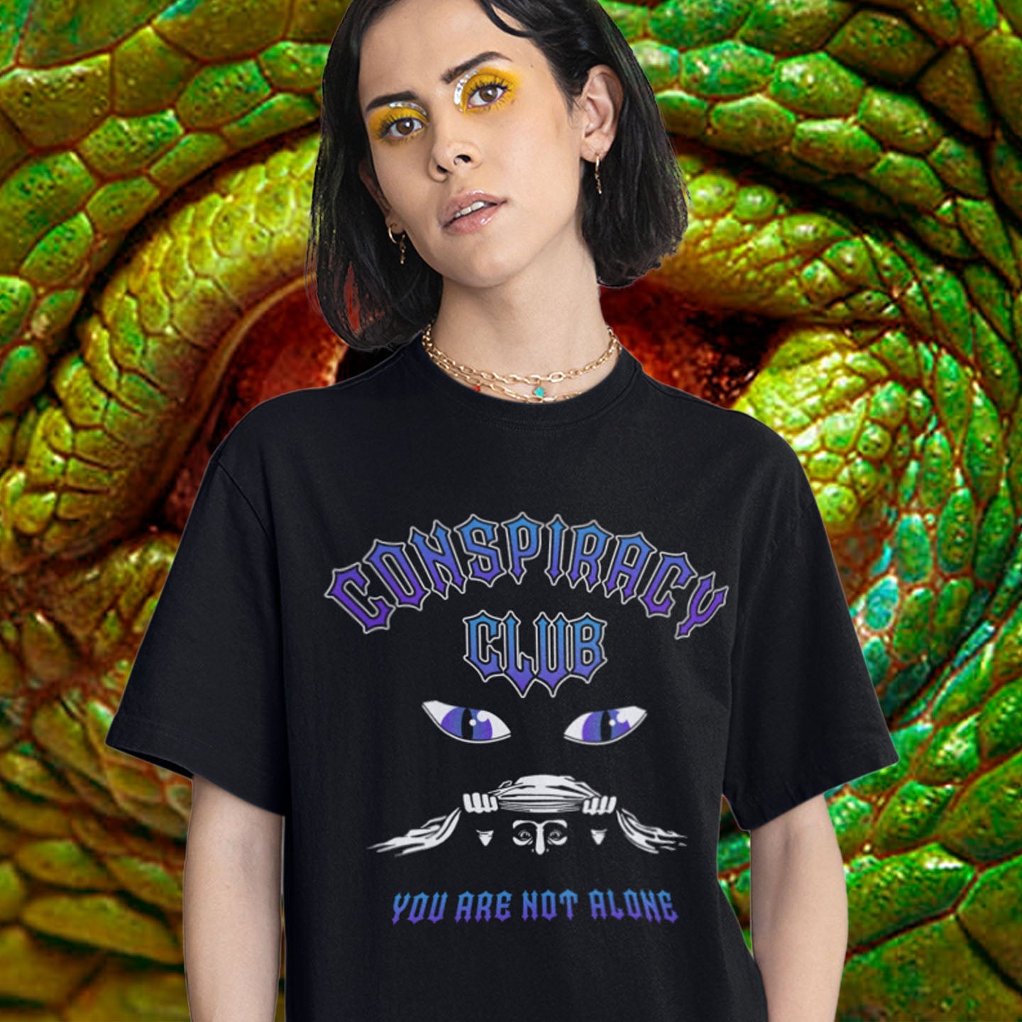 Person wearing a black t-shirt with 'Conspiracy Club' design in front of a snake. A conspiracy theorist t shirt design for all conspiracy lovers who think big brother is watching. join the club, expand your independent thinking, question everything. Think outside the box. Made from 100% organic ring-spun cotton, this funny conspiracy theory t shirt is unisex, high-quality, super comfy, and best of all, eco-friendly.