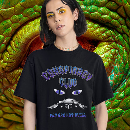 Person wearing a black t-shirt with 'Conspiracy Club' design in front of a snake. A conspiracy theorist t shirt design for all conspiracy lovers who think big brother is watching. join the club, expand your independent thinking, question everything. Think outside the box. Made from 100% organic ring-spun cotton, this funny conspiracy theory t shirt is unisex, high-quality, super comfy, and best of all, eco-friendly.