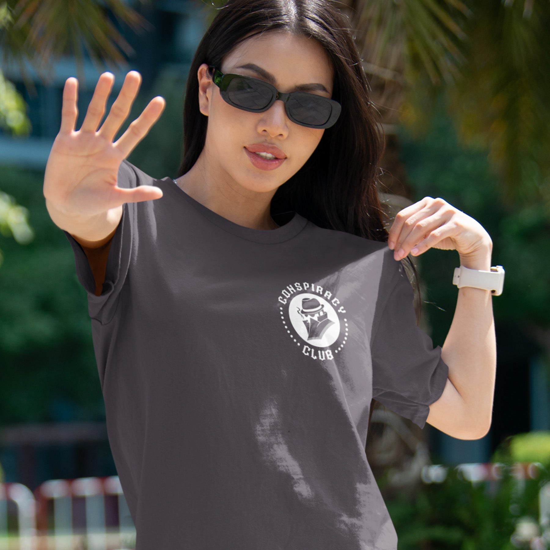 Woman wearing a t-shirt with a 'Conspiracy Club' logo outdoors A conspiracy theorist t shirt. These days there's a conspiracy theory for every occasion, join the club, expand your alternative imagination. Think outside the box. Underground art on apparel. Made from 100% organic ring-spun cotton, these conspiracy theory t shirts are unisex, high-quality, super comfy, and best of all, eco-friendly.