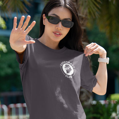 Woman wearing a t-shirt with a 'Conspiracy Club' logo outdoors A conspiracy theorist t shirt. These days there's a conspiracy theory for every occasion, join the club, expand your alternative imagination. Think outside the box. Underground art on apparel. Made from 100% organic ring-spun cotton, these conspiracy theory t shirts are unisex, high-quality, super comfy, and best of all, eco-friendly.