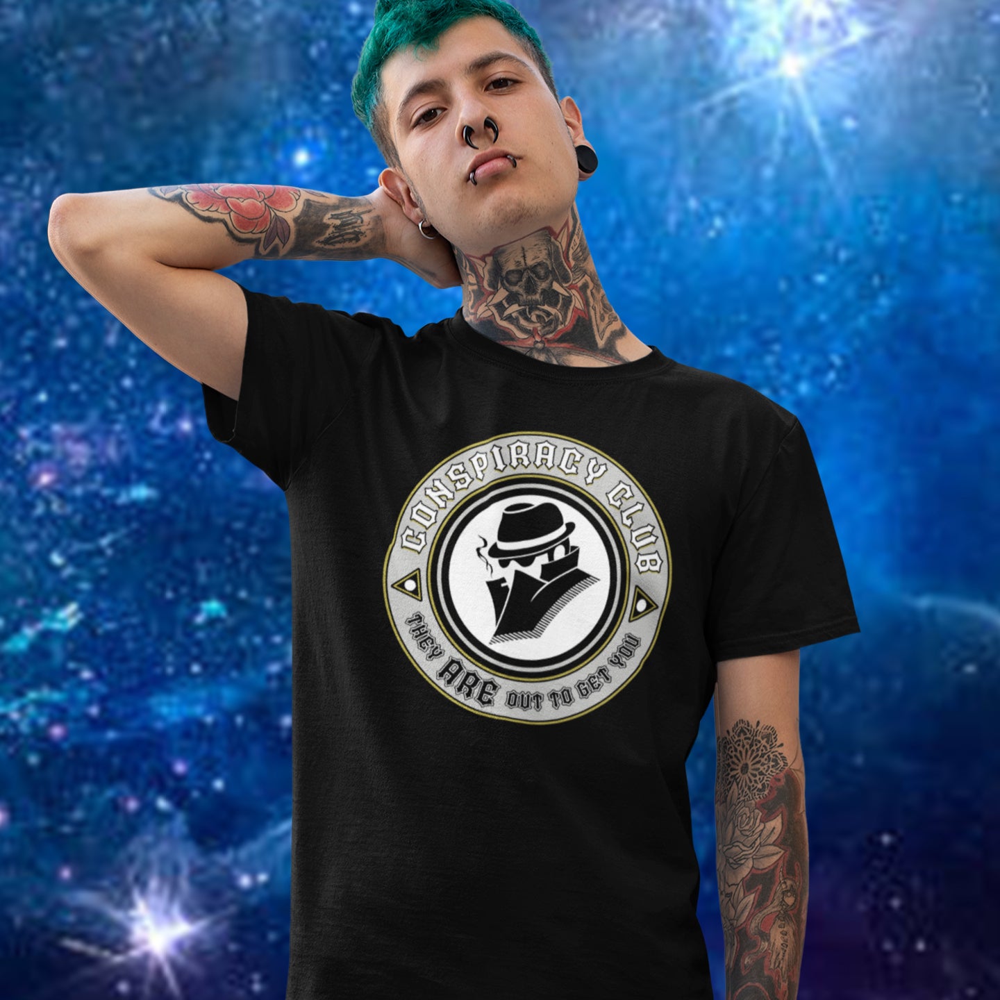 Person wearing a black t-shirt with 'Conspiracy Club' logo against a blue cosmic background. These days there's a conspiracy theory for every occasion, join the club, expand your alternative imagination. Think outside the box. Underground art on apparel. Made from 100% organic ring-spun cotton, this conspiracy theory t-shirt is unisex, high-quality, super comfy, and best of all, eco-friendly.