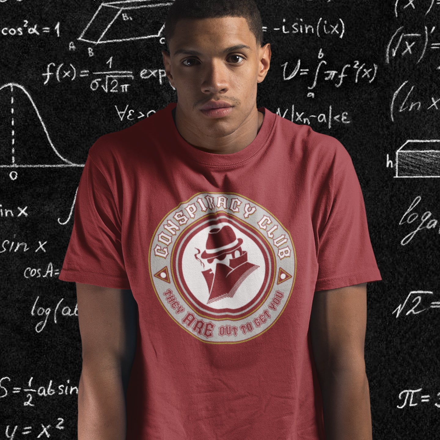 Person wearing a red t-shirt with a 'Conspiracy Club' logo in front of a chalkboard with mathematical  equations. These days there's a conspiracy theory for every occasion, join the club, expand your alternative imagination. Think outside the box. Underground art on apparel. Made from 100% organic ring-spun cotton, this conspiracy theory t-shirt is unisex, high-quality, super comfy, and best of all, eco-friendly.