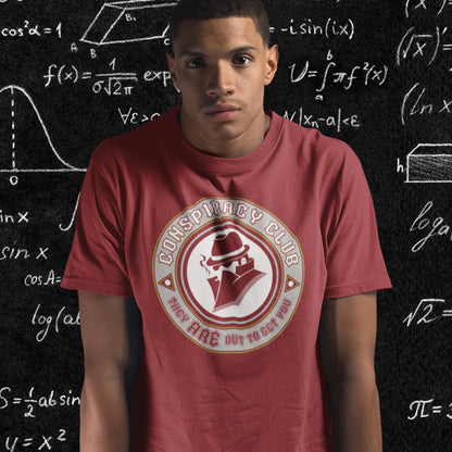 Person wearing a red t-shirt with a 'Conspiracy Club' logo in front of a chalkboard with mathematical  equations. These days there's a conspiracy theory for every occasion, join the club, expand your alternative imagination. Think outside the box. Underground art on apparel. Made from 100% organic ring-spun cotton, this conspiracy theory t-shirt is unisex, high-quality, super comfy, and best of all, eco-friendly.