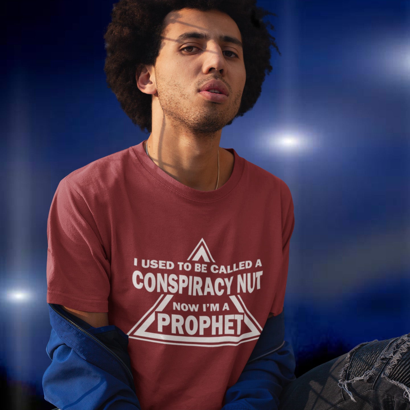 Person wearing a burgundy t-shirt with text against a blue background. This conspiracy theorist t-shirt design is for anyone who used to get funny looks for their alternative view, but now gets greeted with nods of understanding as your earlier rantings come true. Made from 100% organic ring-spun cotton, this conspiracy theorist t-shirt is unisex, high-quality, super comfy, and best of all, eco-friendly.
