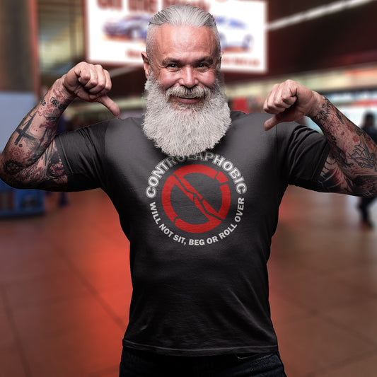 Man with tattoos and a beard wearing an anthracite t-shirt with a red and white graphic design. A satirical non conformist t shirt design suggesting there is a lack of freedom of choice, and too much control, in modern society. If you find yourself unable to follow commands and you're not a dog, You may have controlaphobia. Made from 100% organic ring-spun cotton, this unisex social awareness t shirt is high-quality, super comfy, and best of all, eco-friendly.