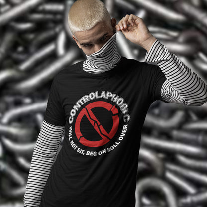 Person wearing a black t-shirt with 'CONTROLAPHOBIC' design against a chain-link fence background. A satirical non conformist t shirt design suggesting there is a lack of freedom of choice, and too much control, in modern society. If you find yourself unable to follow commands and you're not a dog, You may have controlaphobia. Made from 100% organic ring-spun cotton, this unisex social awareness t shirt is high-quality, super comfy, and best of all, eco-friendly.