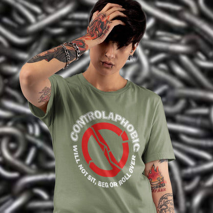 Person wearing a khaki t-shirt with a controlaphobic design against a chain-link fence background. A satirical non conformist t shirt design suggesting there is a lack of freedom of choice, and too much control, in modern society. If you find yourself unable to follow commands and you're not a dog, You may have controlaphobia. Made from 100% organic ring-spun cotton, this unisex social awareness t shirt is high-quality, super comfy, and best of all, eco-friendly.