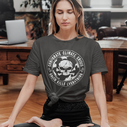Woman wearing a t-shirt with a graphic design sitting in a room. An anti corporate t shirt encouraging social awareness and support to save our planet from corporate negligence. Make it clear you are no fool to where the climate problem blame should be placed with this original design. Made from 100% organic ring-spun cotton, this save the world t shirt is unisex, high-quality, super comfy, and best of all, eco-friendly.