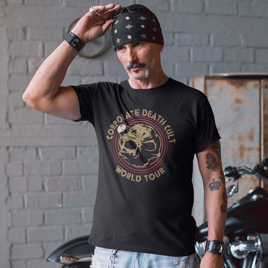 A man with a bandana, holding sunglasses on his head, wearing a black  short sleeved crew neck t-shirt with a skull shaped dead planet graphic with "CORPORATE DEATH CULT WORLD TOUR" printed around it.