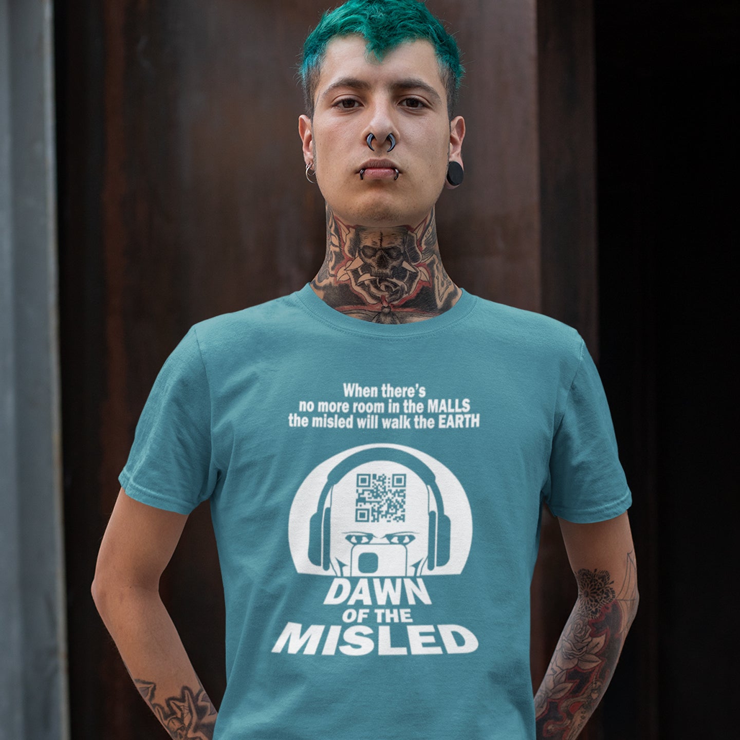 Person wearing a stargazer t-shirt with text and graphics. A counterculture t-shirt in the theme of a famous 1970's horror movie. This satirical design highlights the modern consumer who buys what they are told to buy by social media and corporate advertising. Made from 100% organic ring-spun cotton, this underground anti-consumerism t-shirt is unisex, high-quality, super comfy, and best of all, eco-friendly.