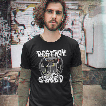 A man wearing a black graphic t-shirt with the words 'DESTROY GREED' in a distressed white font over a circular band photo, layered over a long-sleeve olive green shirt, set against a blurred graffiti wall.
