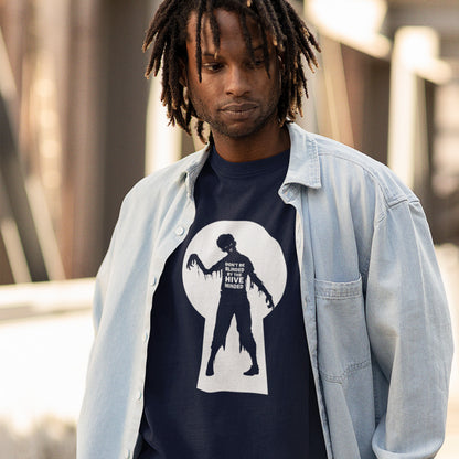 A man wearing a navy blue graphic t-shirt with a white keyhole silhouette and zombie design, layered under a light blue denim shirt. 