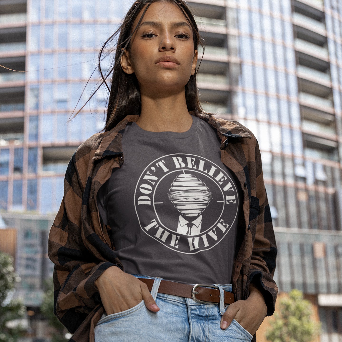 Person wearing a t-shirt with 'Don't Believe The Hype' design in an urban setting. A street art t shirt design for an ever increasing world of media influence and misinformation. Can 'The Majority' be trusted any more ? Don't get blinded by the hive minded. Support independent thought with this unique urban art t shirt. Made from 100% organic ring-spun cotton, this social awareness t shirt is unisex, high-quality, super comfy, and best of all, eco-friendly.