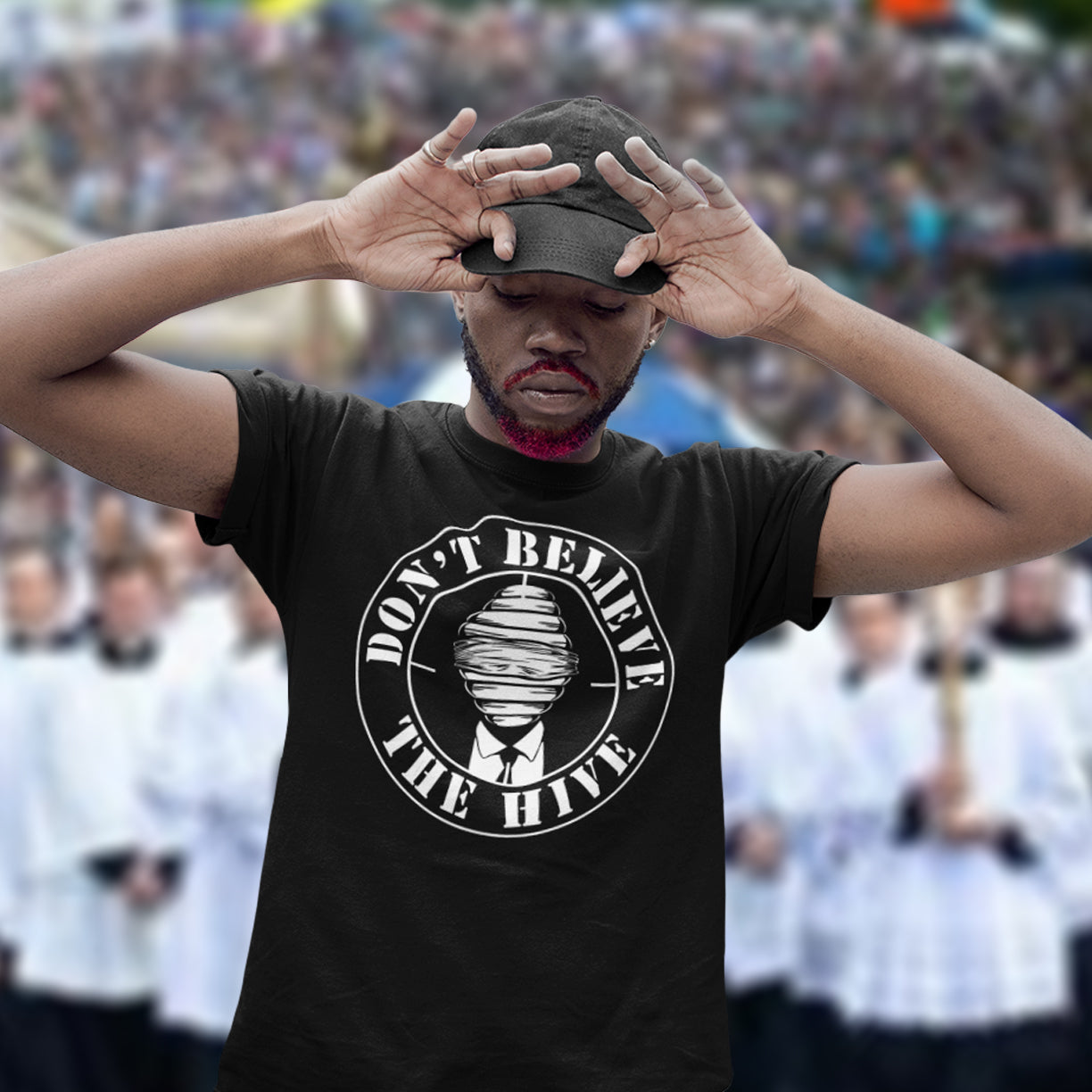 Person wearing a black t-shirt with a graphic and text, standing in front of a blurred crowd. A street art t shirt design for an ever increasing world of media influence and misinformation. Can 'The Majority' be trusted any more ? Don't get blinded by the hive minded. Support independent thought with this unique urban art t shirt. Made from 100% organic ring-spun cotton, this social awareness t shirt is unisex, high-quality, super comfy, and best of all, eco-friendly.
