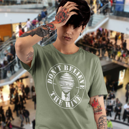 Person wearing a khaki t-shirt with a graphic design in a mall setting. A street art t shirt design for an ever increasing world of media influence and misinformation. Can 'The Majority' be trusted any more ? Don't get blinded by the hive minded. Support independent thought with this unique urban art t shirt. Made from 100% organic ring-spun cotton, this social awareness t shirt is unisex, high-quality, super comfy, and best of all, eco-friendly.