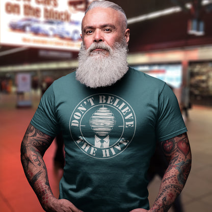 Man wearing a stargazer t-shirt with a logo and text, standing in an indoor setting. A street art t shirt design for an ever increasing world of media influence and misinformation. Can 'The Majority' be trusted any more ? Don't get blinded by the hive minded. Support independent thought with this unique urban art t shirt. Made from 100% organic ring-spun cotton, this social awareness t shirt is unisex, high-quality, super comfy, and best of all, eco-friendly.