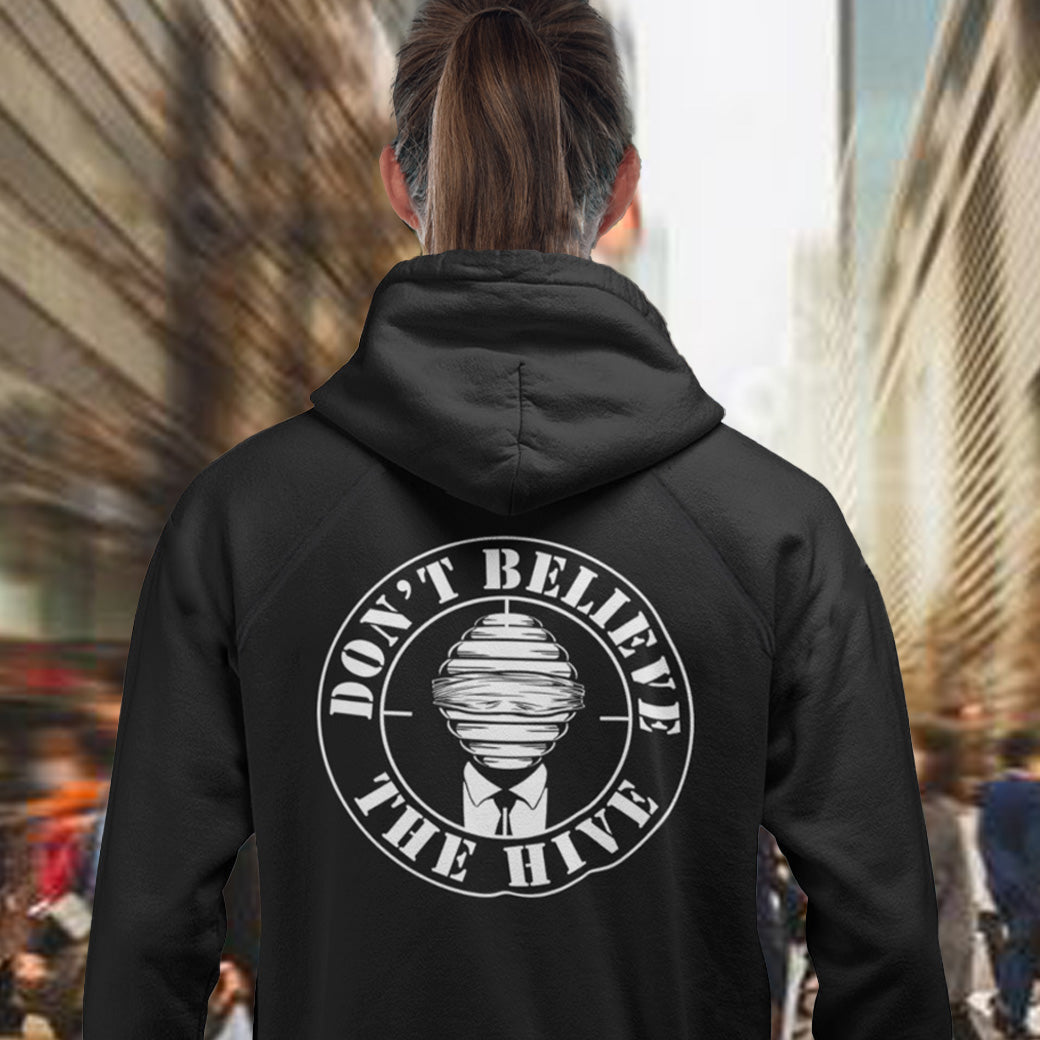 Person wearing a black hoodie with 'Don't Believe The Hive' text on the back in an urban setting. In an ever increasing world of media influence and misinformation, can 'The Majority' no longer be trusted ? Don't get blinded by the hive minded. Support independent thought with this unique hoodie. Comfortable and practical. It's extra soft and has a convenient front pouch pocket. Made from organic cotton and recycled polyester, this social awareness hoodie is a great eco-friendly choice.