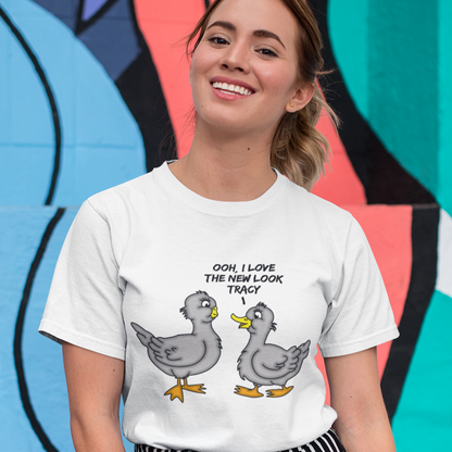 Person wearing a white t-shirt with cartoon ducks and text, standing against a colourful abstract background. A social issues t shirt design mocking the idea of lip fillers. In a alternative reality are ducks having surgery to make their lips look like humans ? Counterculture cartoon. Made from 100% organic ring-spun cotton, this social awareness t shirt is unisex, high-quality, super comfy, and best of all, eco-friendly.