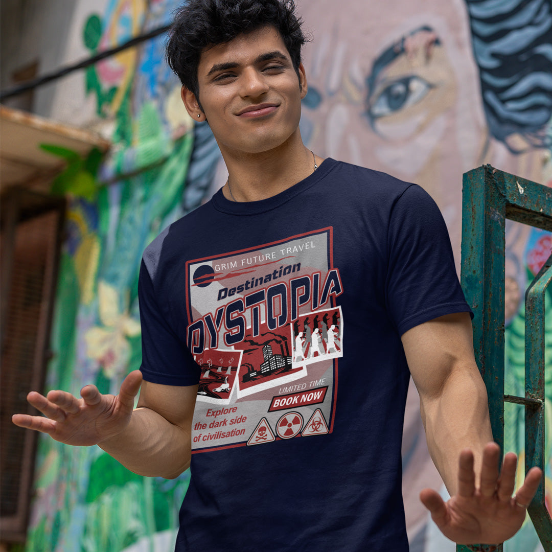 Man wearing a 'Destination Dystopia' t-shirt in front of a colourful mural. This funny dystopian t-shirt design is a clever play on a tourism poster promoting dystopia as a satirical holiday destination. If you feel that our system of inequality will render any holiday to the western world a holiday in Dystopia, this design will truly represent your feelings. Made from 100% organic ring-spun cotton, this broken society t shirt is unisex, high-quality, super comfy, and best of all, eco-friendly.