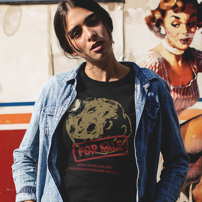 Person wearing a black t-shirt with a graphic design in front of a colourful mural. A save the world t-shirt design playing on the car sales slogan 'One careful previous owner' You know we'll try to sell the planet when we're finished with it. Environmental awareness sooner than later. Made from 100% organic ring-spun cotton, this save the earth t shirt is unisex, high-quality, super comfy, and best of all, eco-friendly.