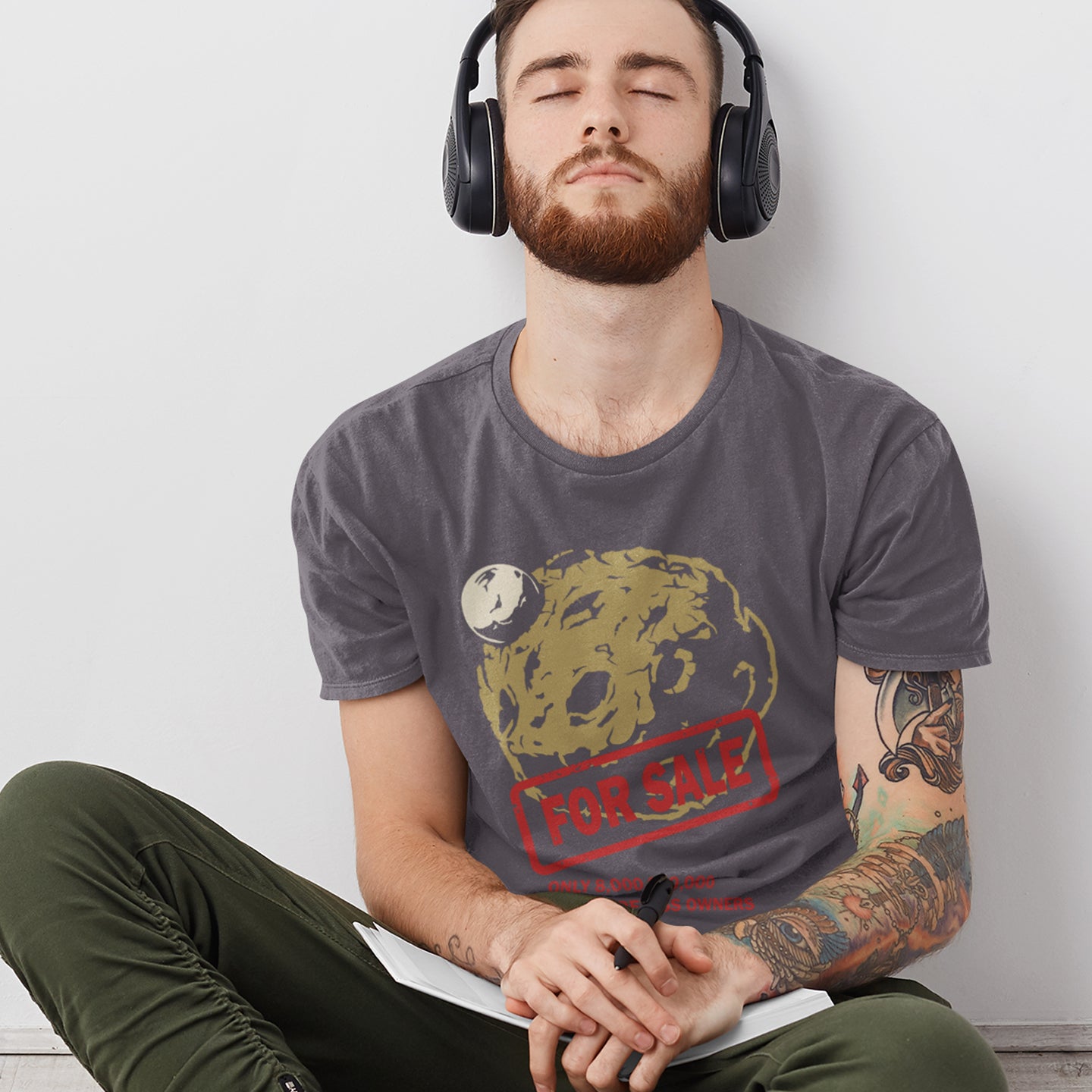 Man wearing headphones and a t-shirt with a graphic design sitting against a white wall. A futuristic environmental t-shirt design playing on the car sales slogan 'One careful previous owner' You know we'll try to sell the planet when we're finished with it. Climate awareness sooner than later. Made from 100% organic ring-spun cotton, this climate concern t-shirt is unisex, high-quality, super comfy, and best of all, eco-friendly.