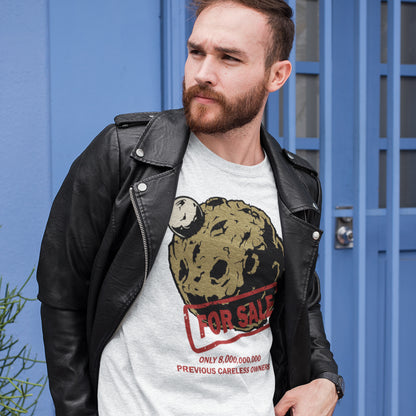 Man wearing a white t-shirt with a graphic design in front of a blue door. A futuristic environmental t-shirt design playing on the car sales slogan 'One careful previous owner' You know we'll try to sell the planet when we're finished with it. Climate awareness sooner than later. Made from 100% organic ring-spun cotton, this climate concern t-shirt is unisex, high-quality, super comfy, and best of all, eco-friendly.