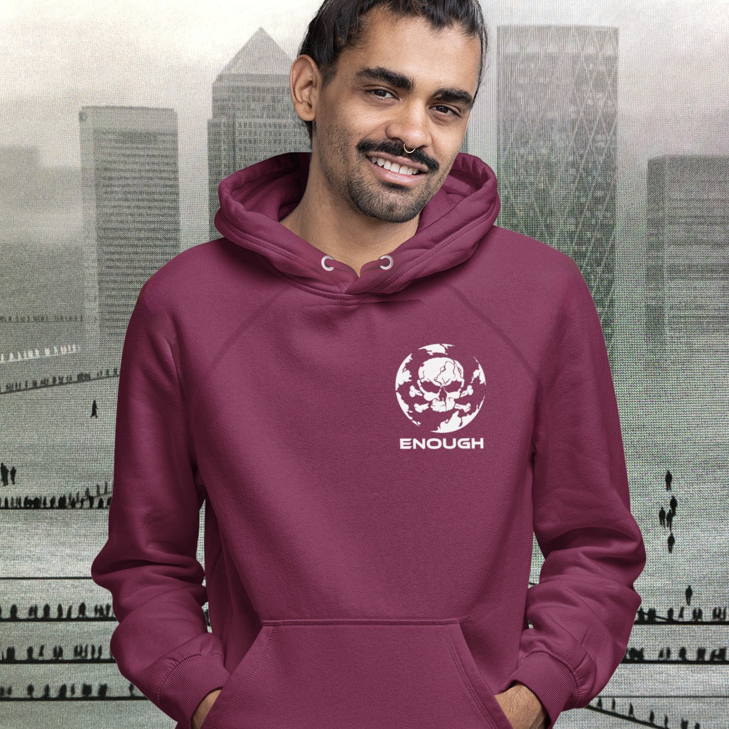 Man in burgundy hoodie standing in front of a picture of Canary Wharf. An environmental hoodie highlighting an overcrowding concern. This original design is for all nature lovers who think that enough is enough and don't want to live in a concrete jungle. Comfortable and practical. It's extra soft and has a convenient front pouch pocket. Made from organic cotton and recycled polyester, this social awareness hoodie is a great eco-friendly choice.