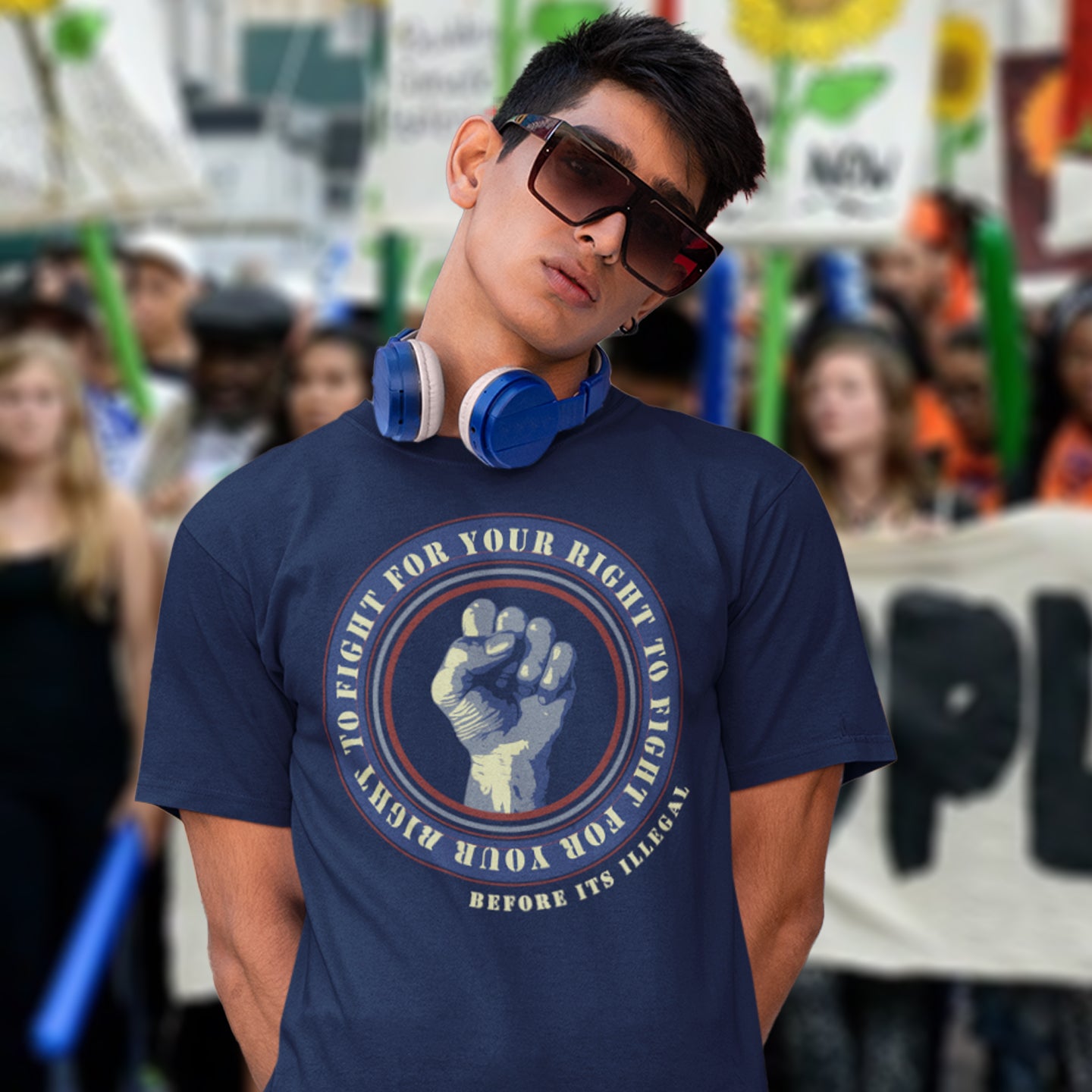 Person wearing a French navy blue t-shirt with a graphic design and text, standing in a crowd. A civil rights t-shirt reminding us not to take our freedom for granted. Fight for your right to demonstrate before it's made illegal. Made from 100% organic ring-spun cotton, this anti-establishment t-shirt is unisex, high-quality, super comfy, and best of all, eco-friendly.